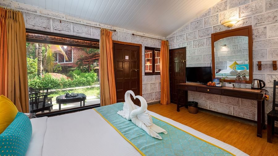 Lotus eco beach resort, dove towel on king size bed at Konkan Cottage - Gallery of Lotus Eco Beach Resort, Murud
