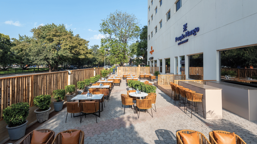 Clean bathroom at Mango Grove with tiled walls, shower, and bathroom essentials.