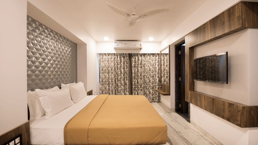 side view of deluxe room at  adamo sanmukh with its clean ambience and modern interior .