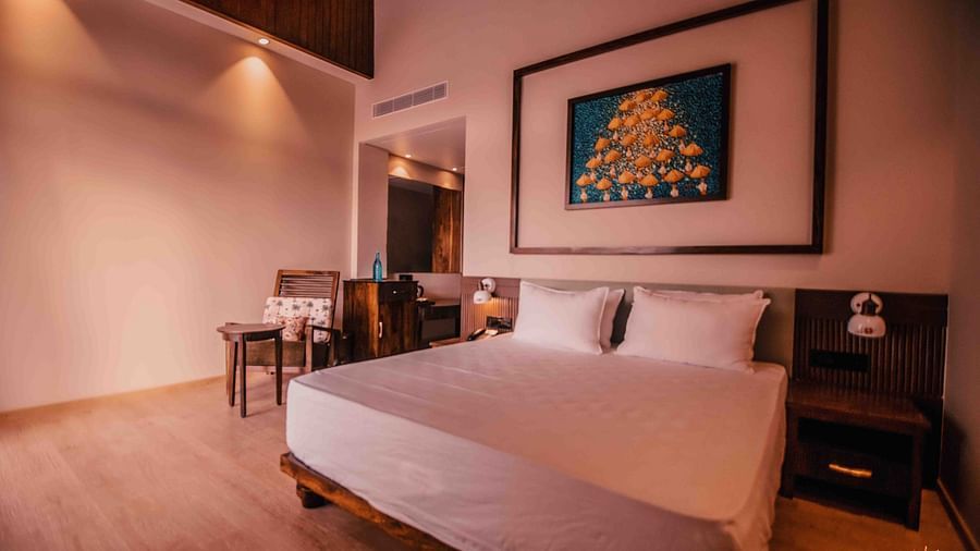 casa tropicana rooms with a double bed and side table at Symphony Samudra Beachside Jungle Resort And Spa, Port Blair