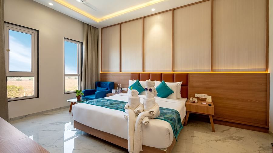 The orchid suite having a King Size bed, with decorations of towels folded to look like a couple. - The Orchid Hotel, Jamnagar
