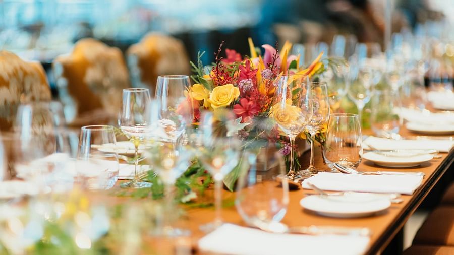 An image of a table setting with wine glasses and cutlery arranged for dining.