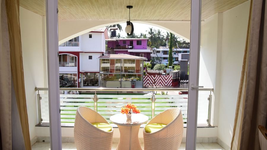 a view of the balcony and seats on it inside one of the rooms at VITS shanti solitaire, North Goa