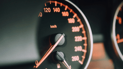 A close up shot of a dashboard of a car with the speedometer in view