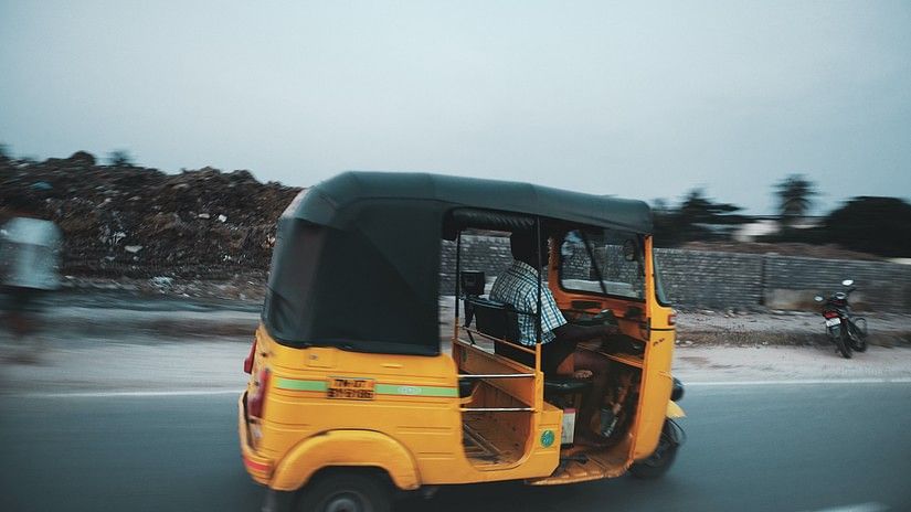 an Autorickshaw travelling on the road