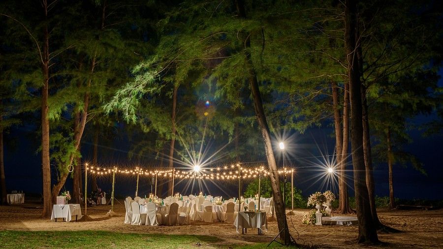 image of the dining area under a lush green canopy in the night time with beautiful yellow bulbs - Maikhao Dream Villa Resort & Spa, Phuket