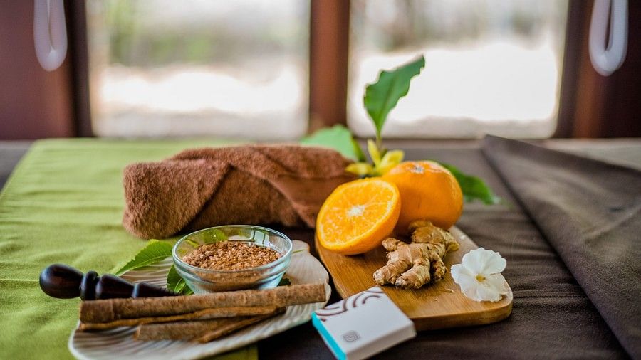 fruit, a towel and other items on a bed at our resort in Bandipur