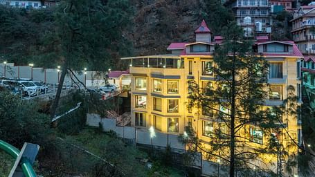 exterior view of the DLS Rock Castle illuminating yellow lights in the evening.