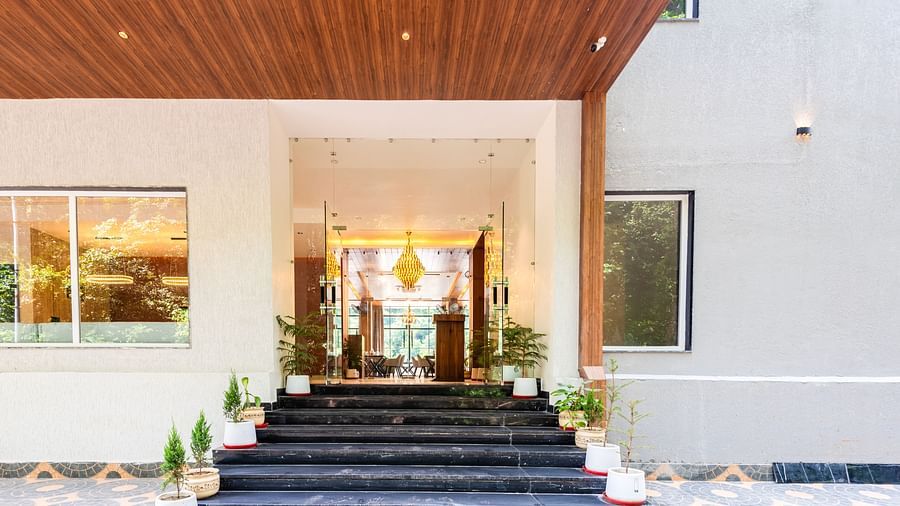 Entrance of  DLS Divine River Resort and Spa with large staircase leading to the door.
