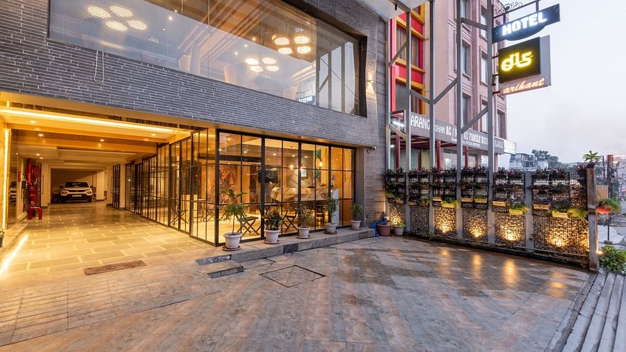 Exterior image of DLS Hotel Arihant, Haridwar with bright yellow lighting