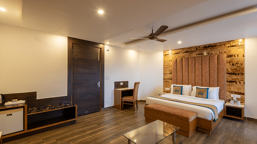 A modern premium room with a comfortable bed, work desk, and sleek wooden interiors for a relaxing stay - DLS Meghavan Resort, Dharamshala