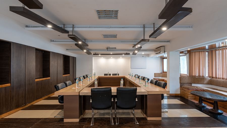 Conference Hall  at DLS Spring Valley Resort Dharamshala  with chairs and tables arranged in boardroom setting 
