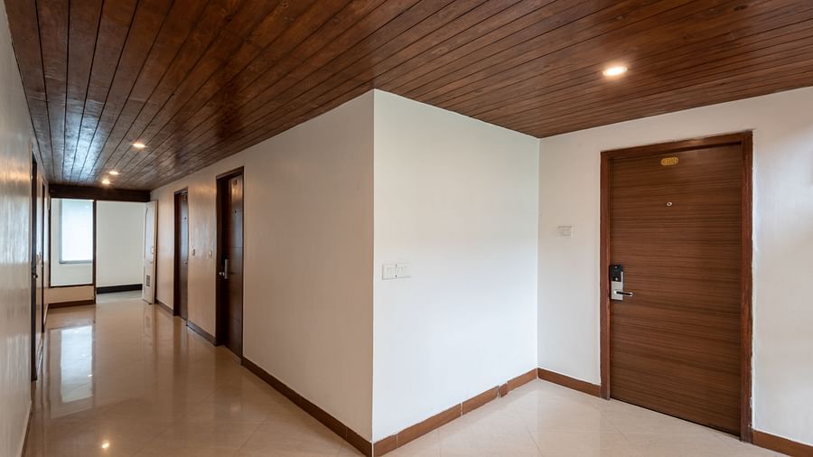 Lobby corridor at DLS Spring Valley Resort Dharamshala with wooden ceiling