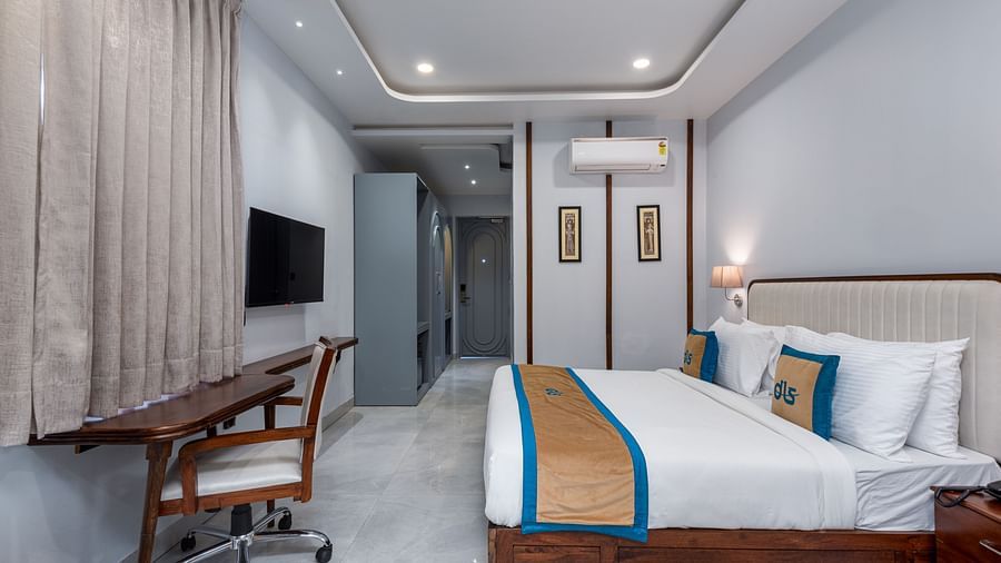 Spring Suite at DLS Spring Valley Resort Dharamshala featuring a kind bed, work desk and chair and ambient lighting
