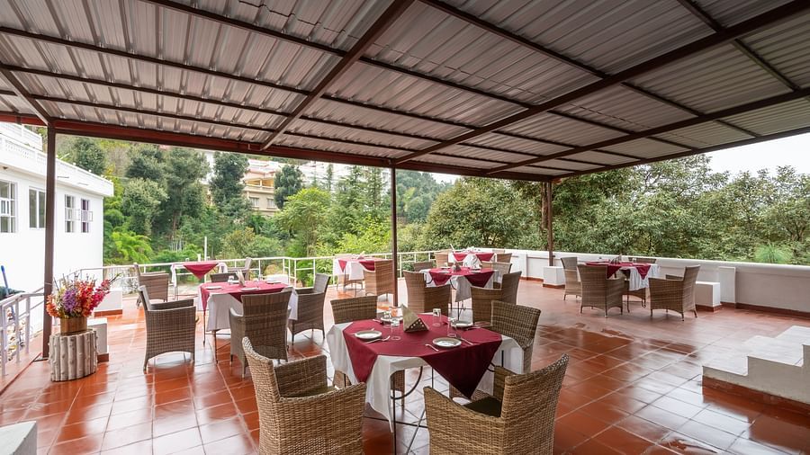 Tables set for an al fresco dining experience at DLS Tehri Club Resort.