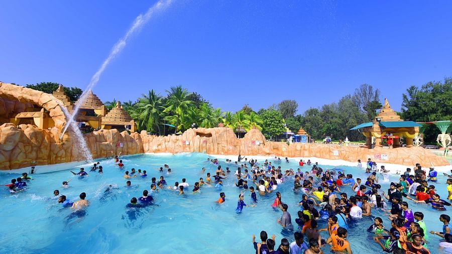 Water Kingdom - multiple groups of people playing at a pool during daytime
