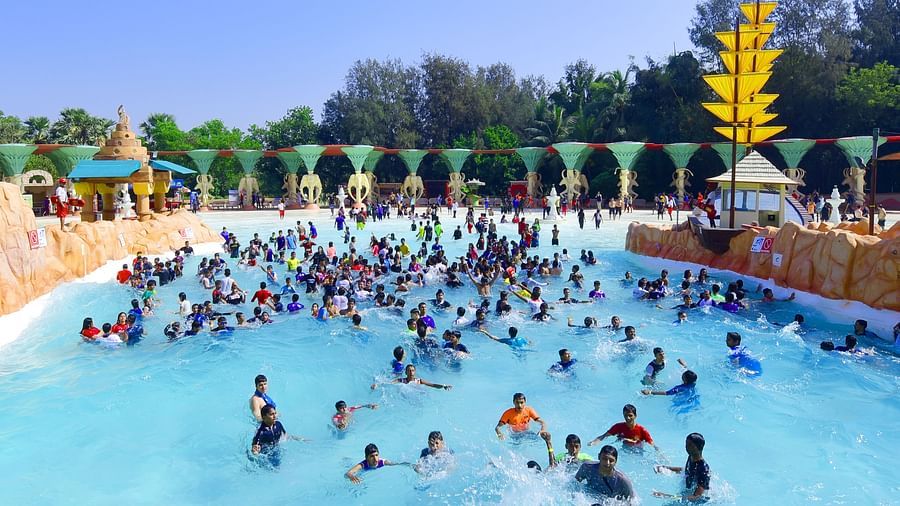 Water Kingdom - wide angle view of multiple people in a poop during daytime