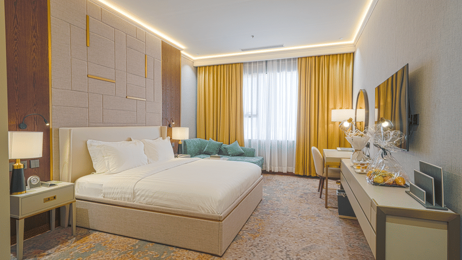 A Standard King Room at Grand Iva Hotel, Abha, seen with the plush bed facing the TV, table, and work desk.
