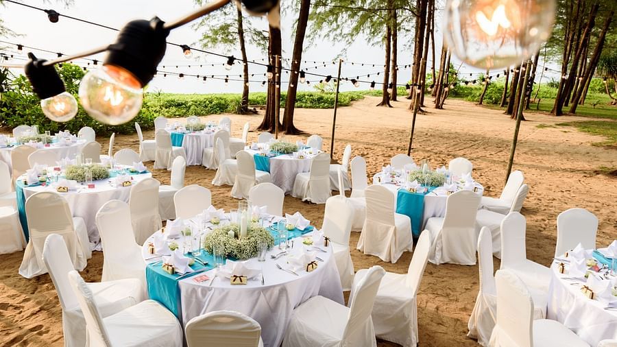 The entire dining setup with round tables on the beach side - Maikhao Dream Villa Resort & Spa, Phuket