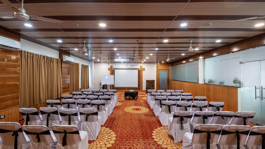 Rows of chairs aligned in a meeting hall at DLS Hotels On The Ganges.