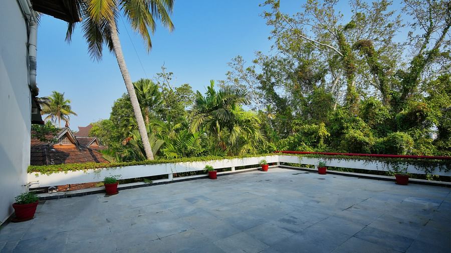 an image of a terrace with a garden view - Rhythm Kumarakom