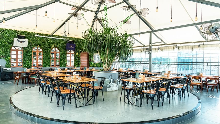 A wide view of chairs and table at a circular stand at Kyba restaurant at Visthara - Urban Boutique Hotel 12