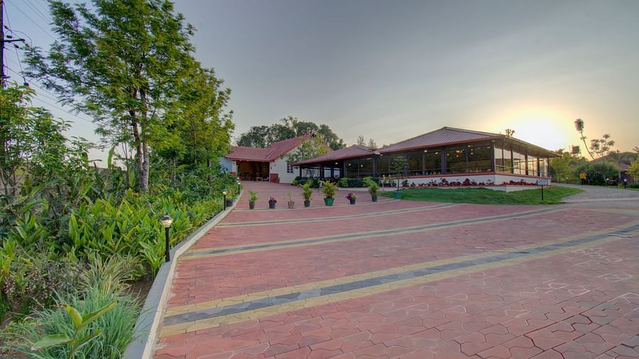 Tiled floor with a house , sunset and greenery | Woodstock Resorts, Coorg