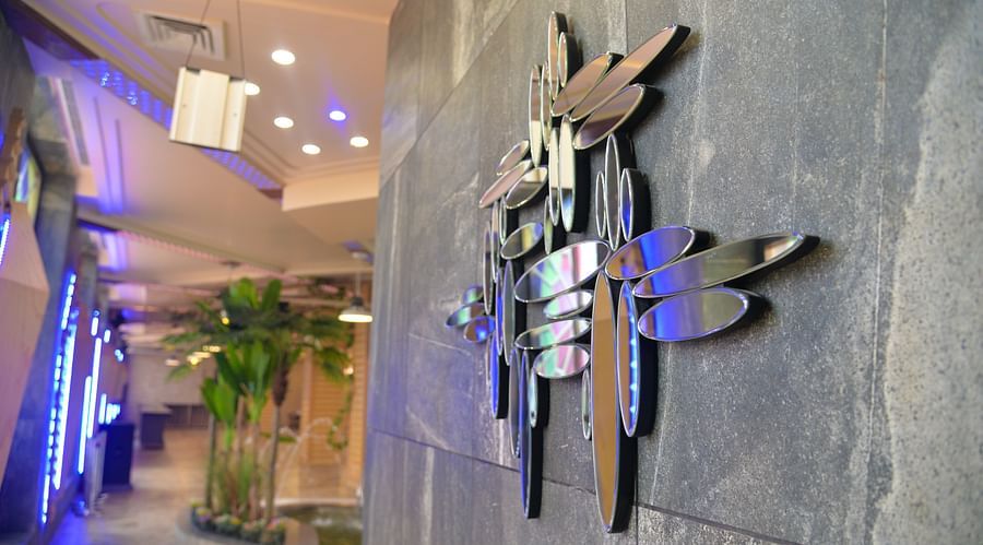 A mirror decor on a wall - Golden Imperial Resorts Lucknow