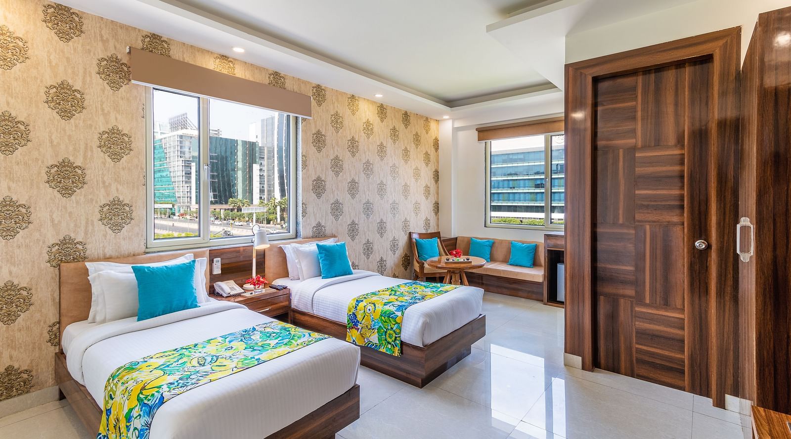 Image of Super Deluxe Twin Room featuring twin beds, sofa, a window and a TV | Inde Hotel Cyber City