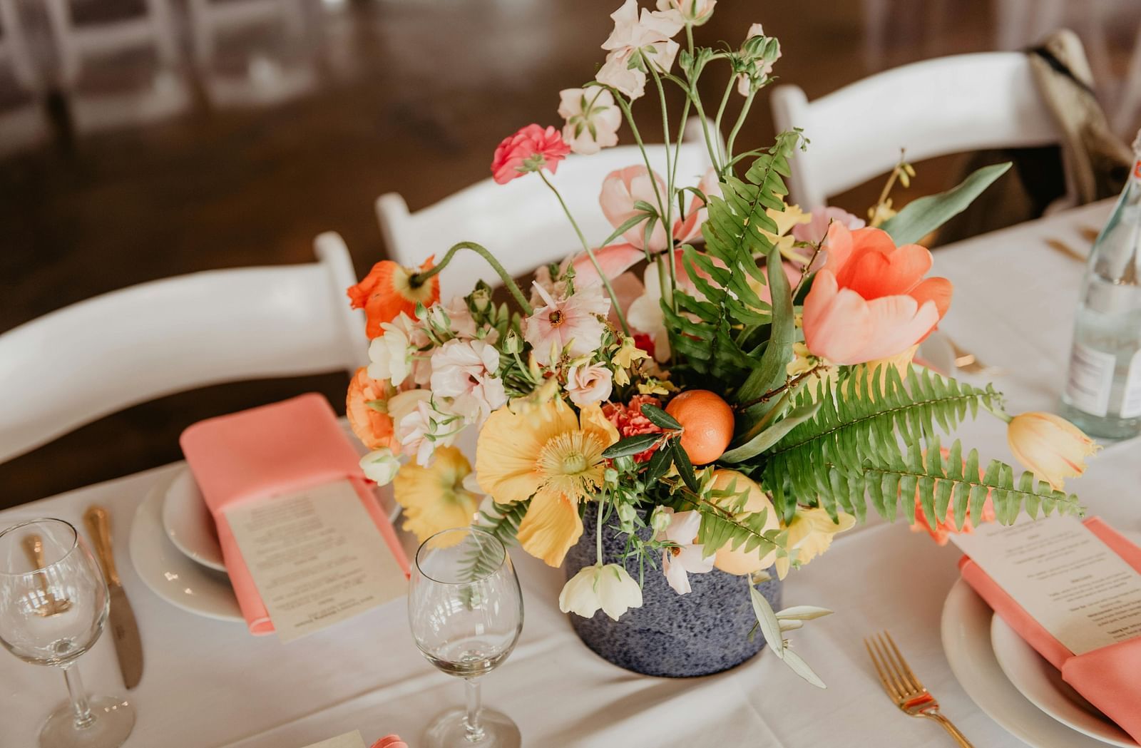 Assorted flowers made into a bouquet placed inside a vase on a table