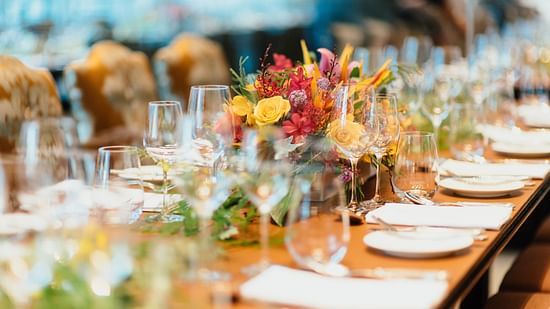 Image of a table decorated with cutlery in a banquet hall