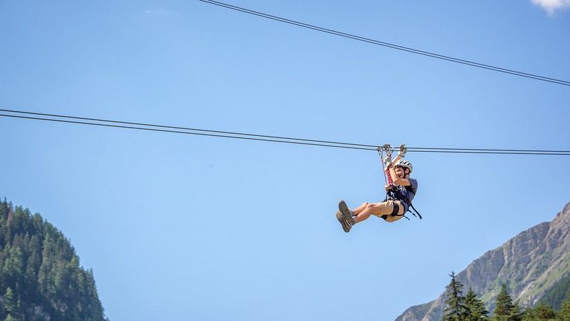 a child ziplining during daytime