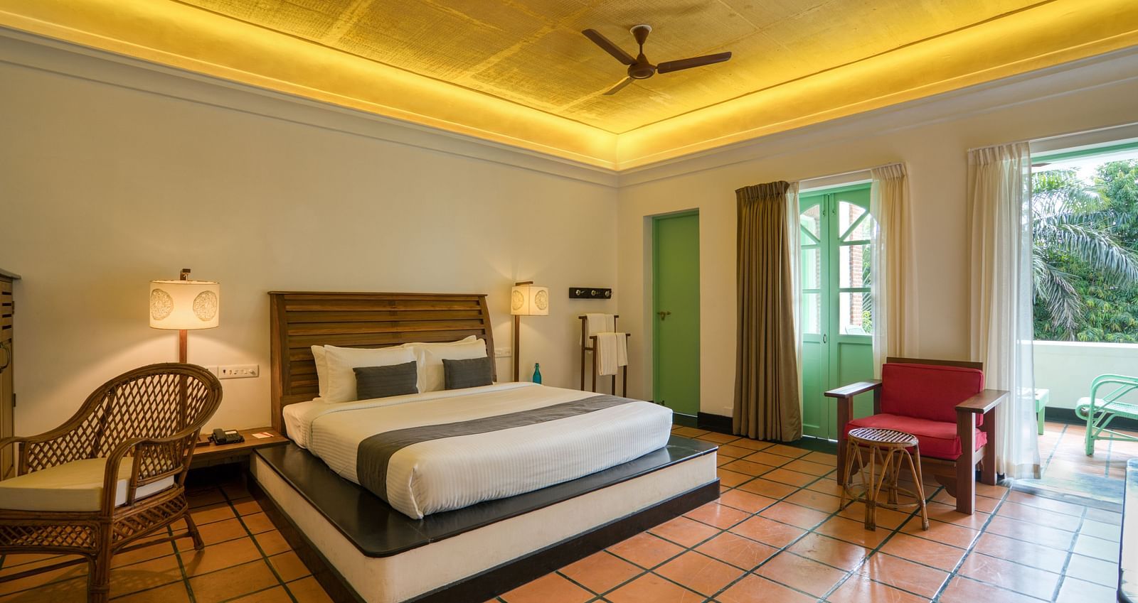 French Classic Bedroom at Mango Hill Auroville, Pondicherry featuring a plush bed in warm lighting as the daylight lights up the room