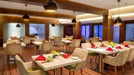Dining of a restaurant at Grand Vijayawada by GRT Hotels.