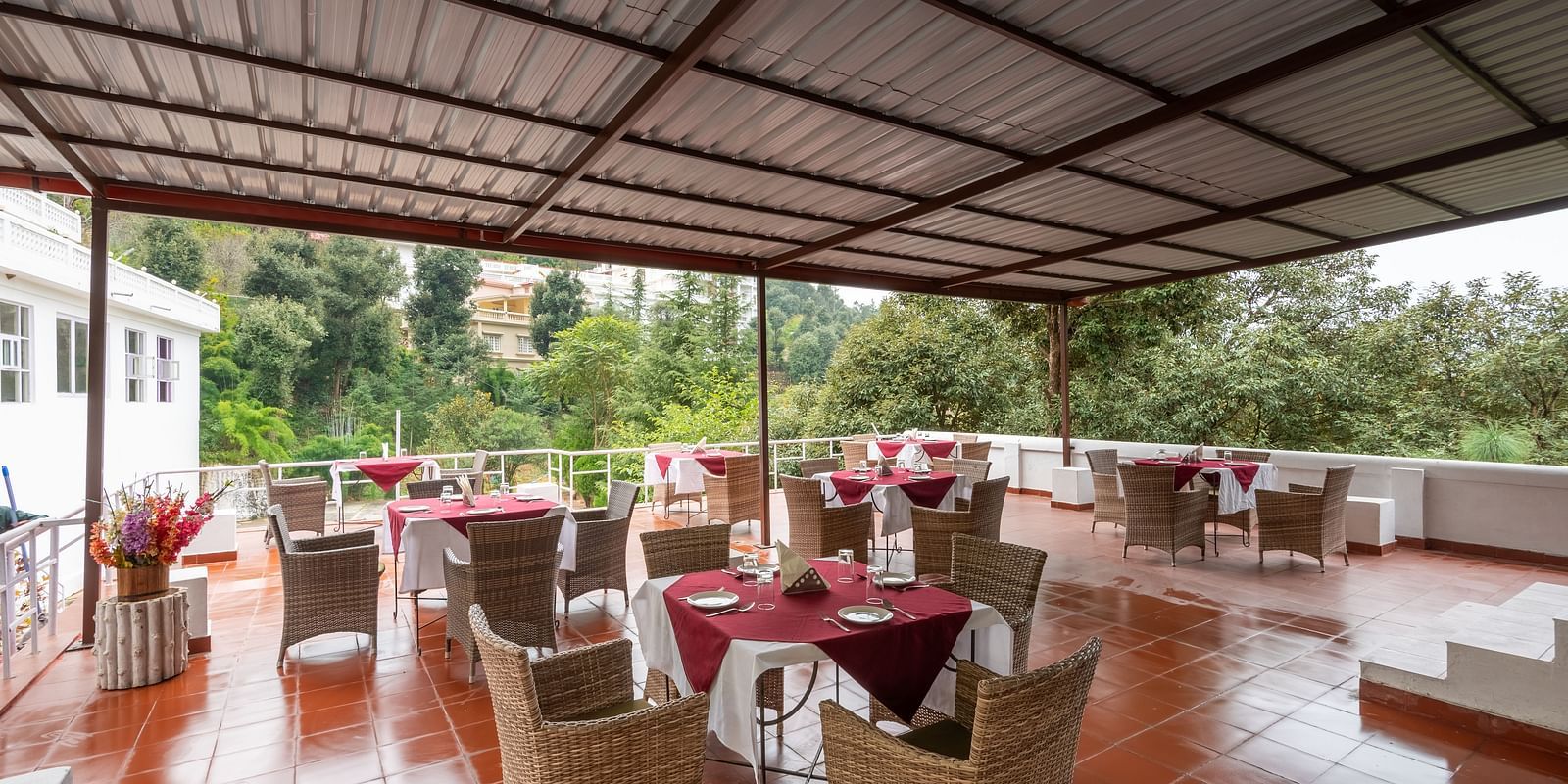 Tables set for an al fresco dining experience at DLS Tehri Club Resort.