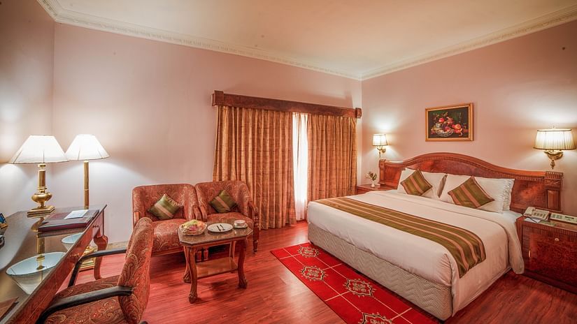 a double bed accommodation near Chennai Central with side tables, lamps and a sofa on the side - Raj Park Hotel, Chennai
