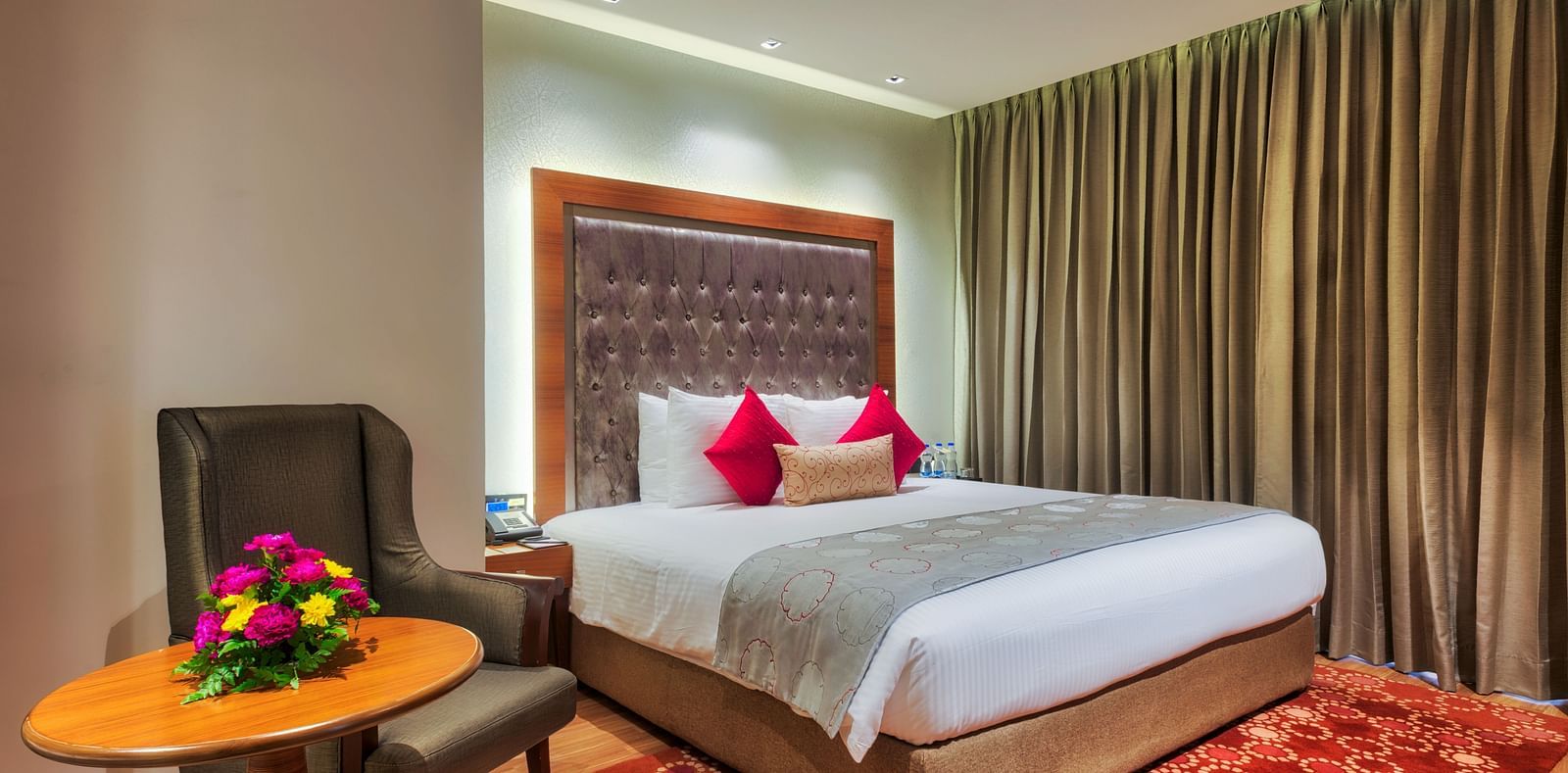 View of the king size bed of a Deluxe Suite at at Grand Chennai By GRT Hotels.