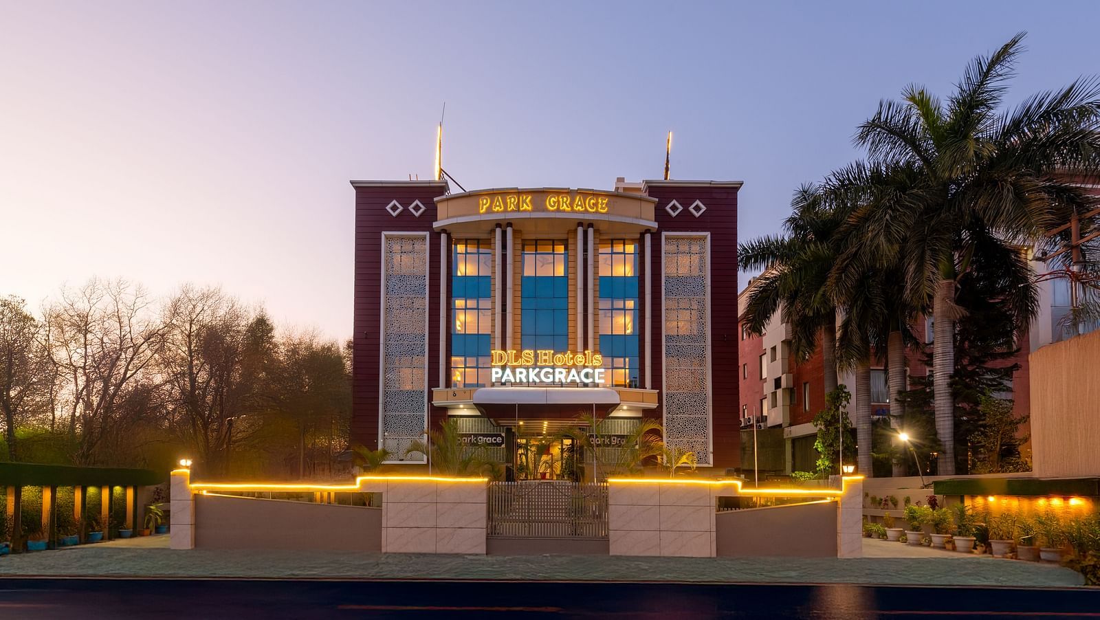 Facade of DLS Park Grace hotel in Haridwar decorated with lights.