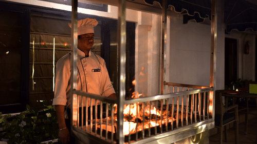 a chef grilling kebabs