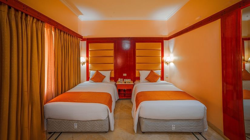 twin beds in a bedroom at Superior Room at hotel Raj Park, Chennai