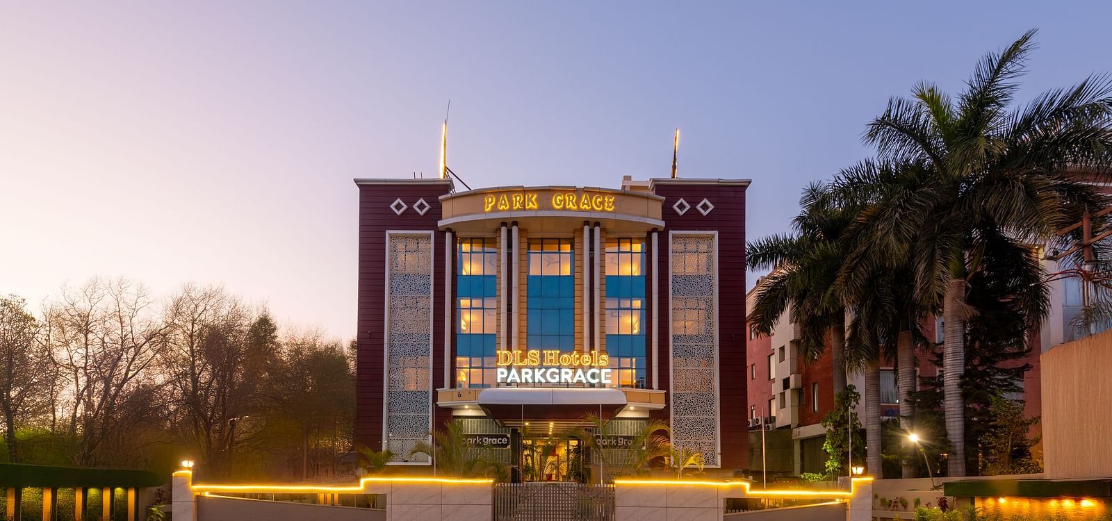 Facade of DLS Park Grace hotel in Haridwar decorated with lights.