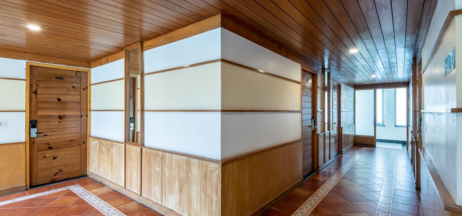 Lobby corridor at DLS Spring Valley Resort Dharamshala with wooden flooring