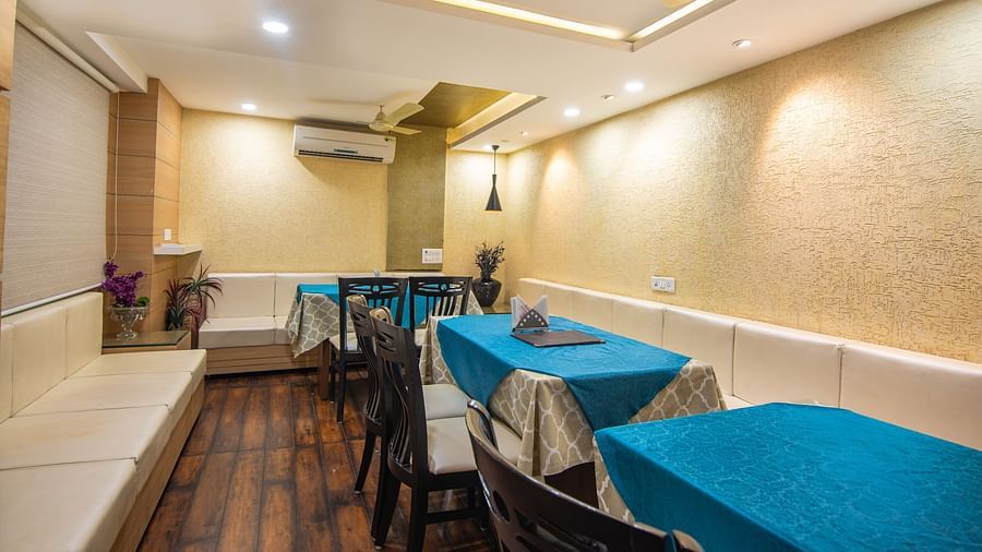a dining area featuring a bunch of tables and chairs - Hotel Morya, Bhopal