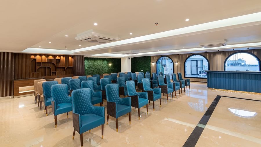 A shot of the banquet hall with chairs and huge windows on the right - DLS Grand Luxotica, Dehradun