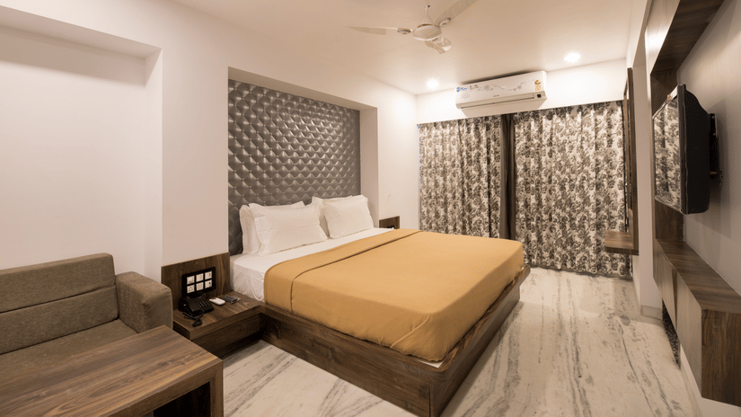 Deluxe room at  sanmukh adamo with  its clean ambience .