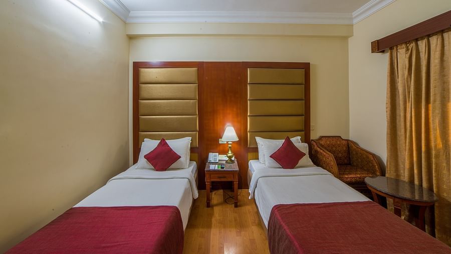 twin beds in a bedroom at Deluxe Roomat  Raj Park Hotel, Chennai