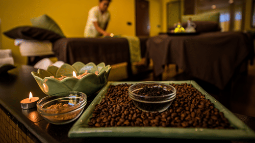 coffee beans kept on a table with a staff cleaning the room in the background