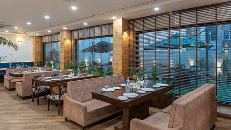 Seating area of a restaurant featuring multiple sofas arranged at DLS The Classio