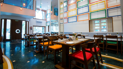 seatings arrangements inside the restaurant with plates kept on the table - VITS Sharanam, Thane