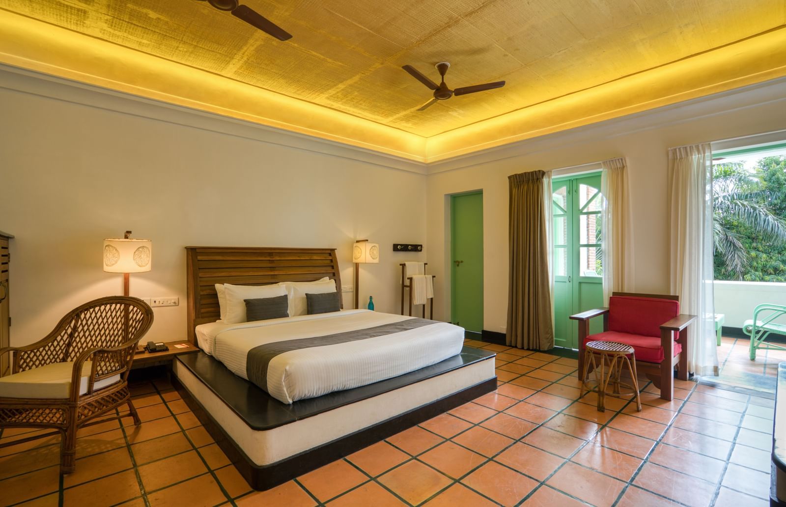 French Classic Bedroom at Mango Hill Auroville, Pondicherry featuring a plush bed in warm lighting as the daylight lights up the room